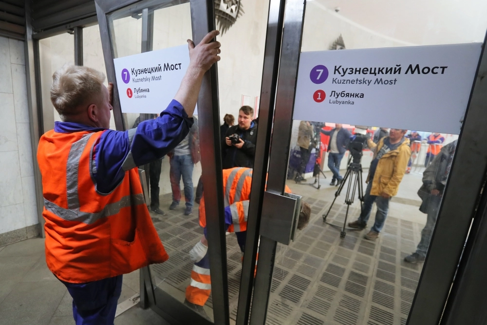 Сотрудники московского метрополитена снимают вторые вестибюльные двери во время уборки станции «Кузнецкий мост».