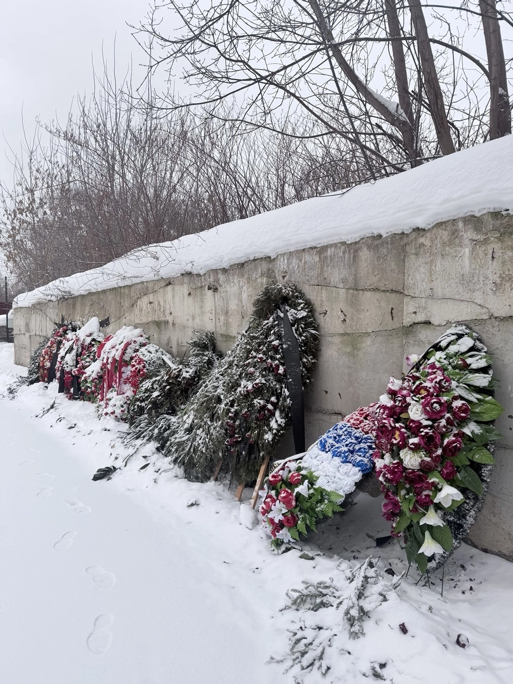 Рядом - множество венков.