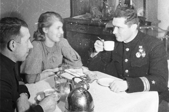 Герой Советского Союза летчик-истребитель Б.Ф. Сафонов со своей женой Евгенией и комиссаром авиаполка П. Редьковым за чаепитием. Фотография сделана в квартире Б.Ф. Сафонова в Ваенге (сейчас город Североморск).