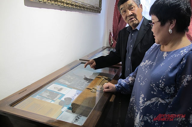 Внук и правнучка Цокто Бадмажапова у музейного стенда, посвящённого их предку.