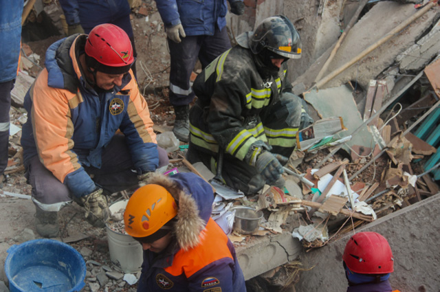 Сотрудники МЧС РФ разбирают завалы разрушенного в результате взрыва дома в поселке Корфовский в Хабаровском крае.
